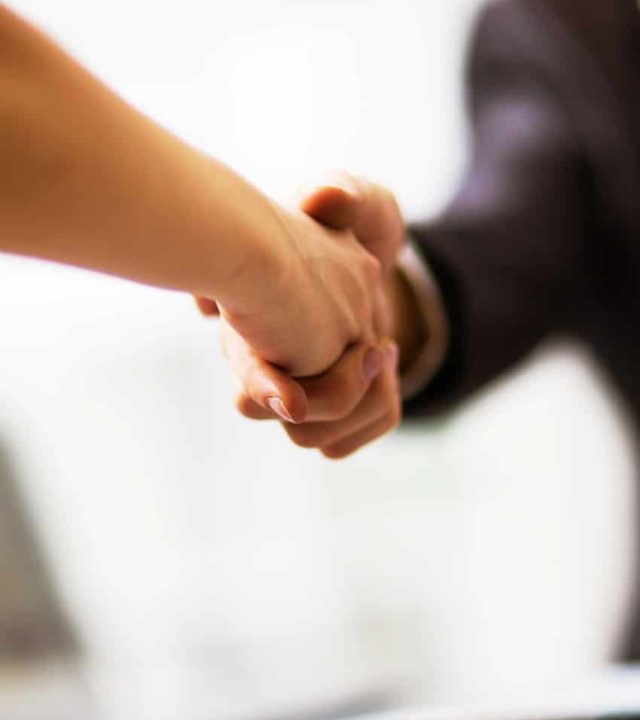 Business people shaking hands, finishing up a meeting Business people shaking hands, finishing up a meeting
